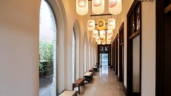 A long corridor inside a public building with closed doors along one side