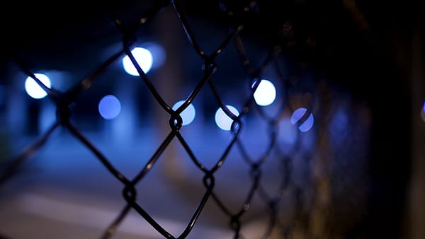 A chain link fence photographed in close-up, the wire mesh filling the frame