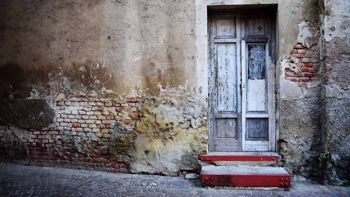 A closed residential front door photographed straight on in flat daylight