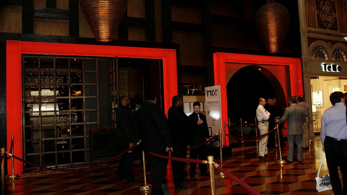 Retractable queue barriers set out across an entrance with nobody waiting